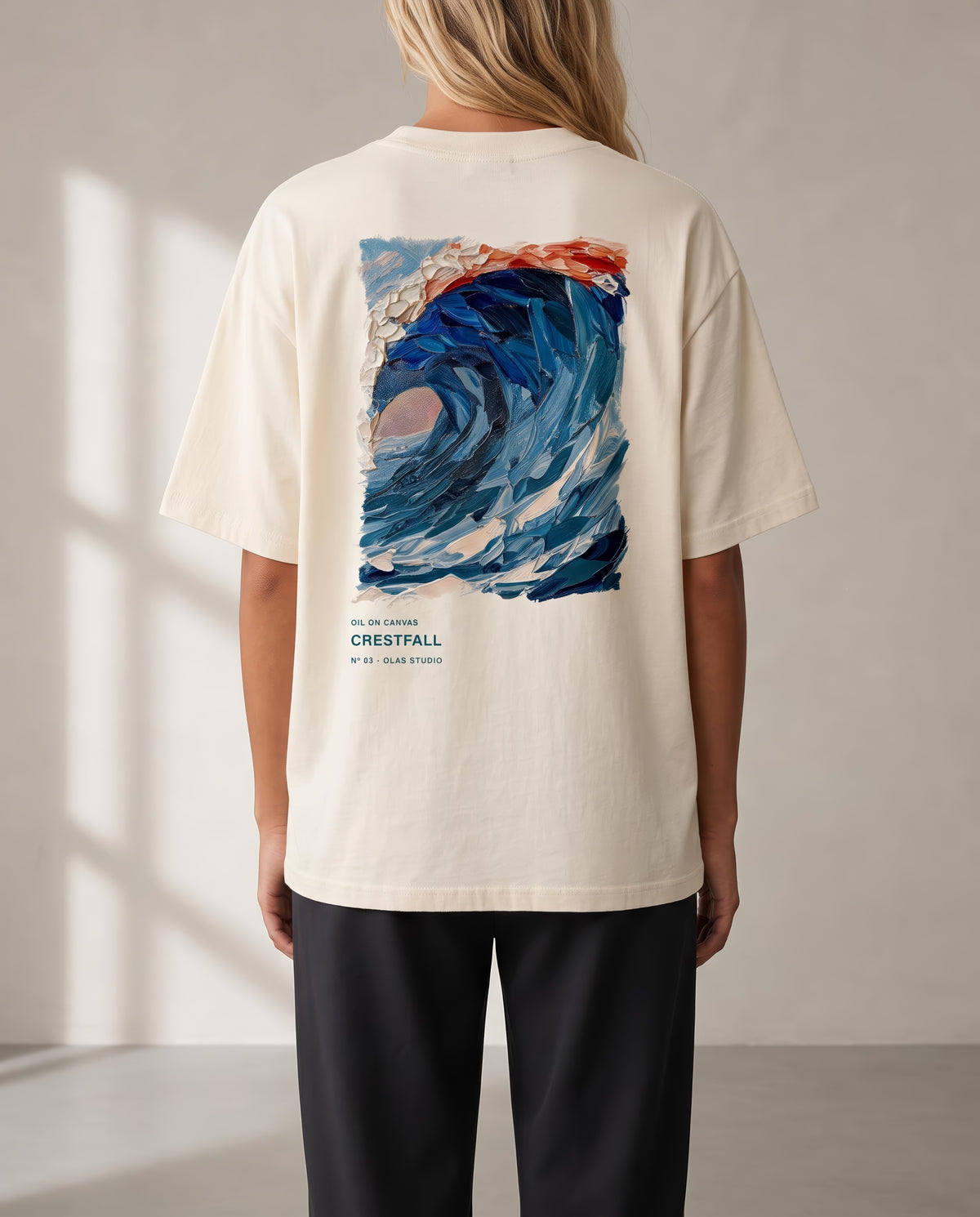 A model seen from the back in the Crestfall tee, the work printed large across the upper back