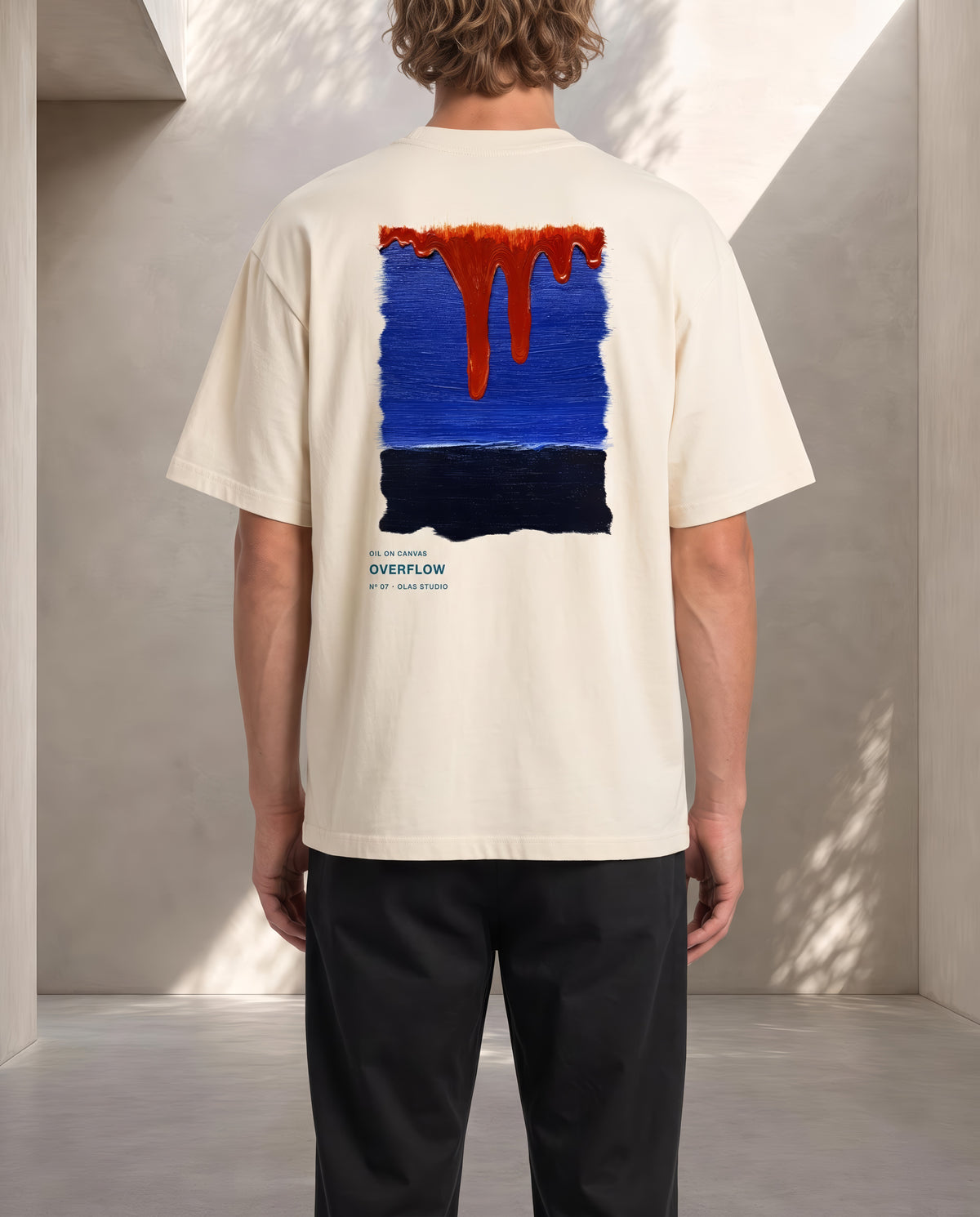 A model seen from the back in the Overflow tee, the work printed large across the upper back