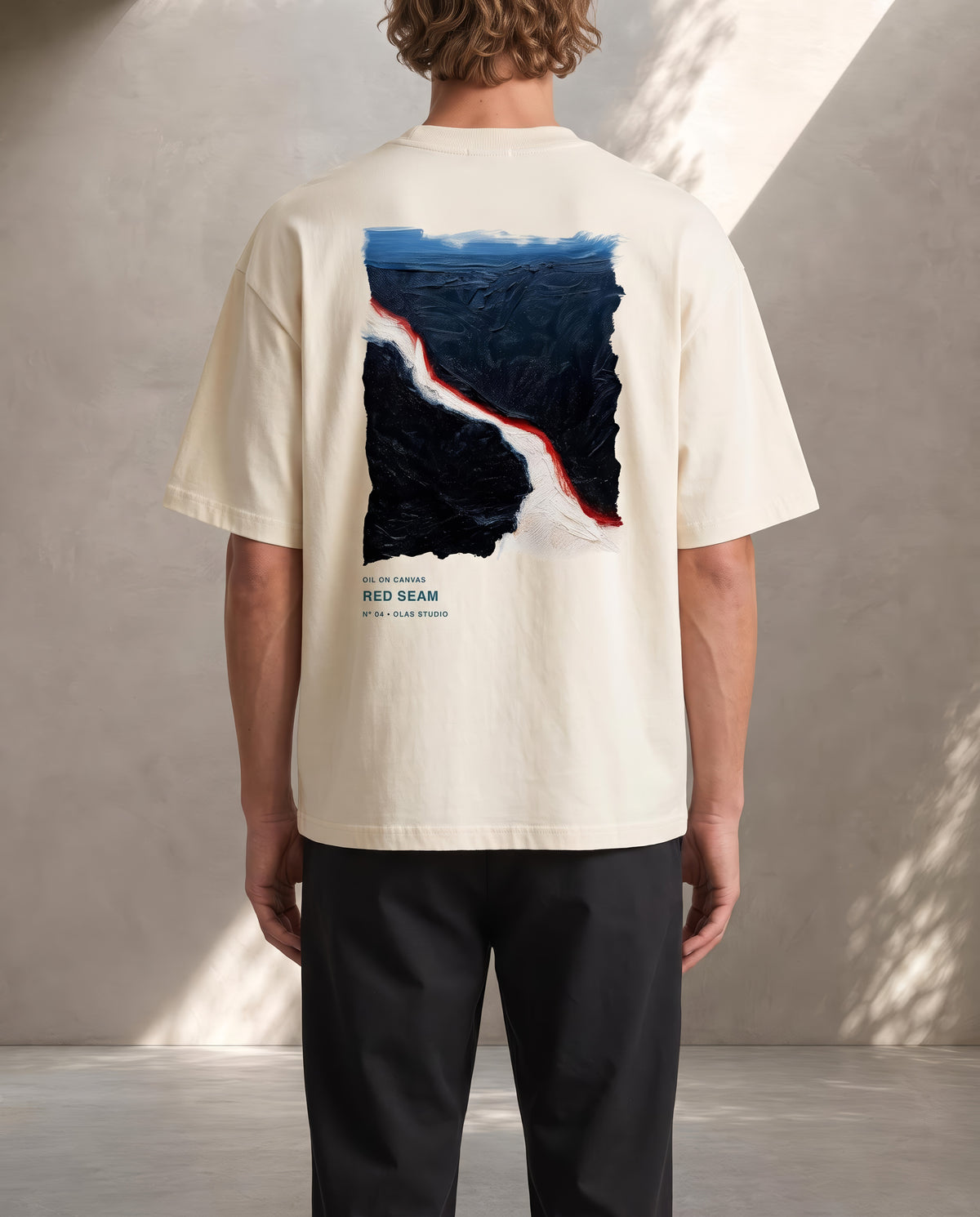 A model seen from the back in the Red Seam tee, the work printed large across the upper back