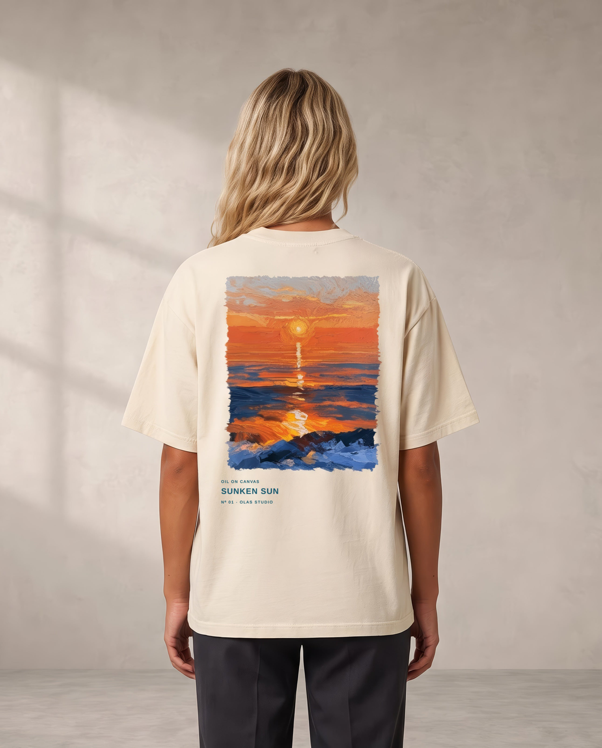 A model seen from the back in the Sunken Sun tee, the work printed large across the upper back