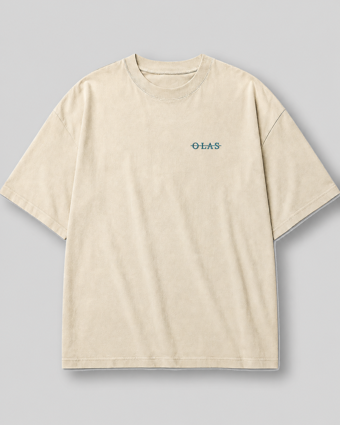 Front of a cream heavyweight Olas Studio T-shirt with the crossed Olas chest mark